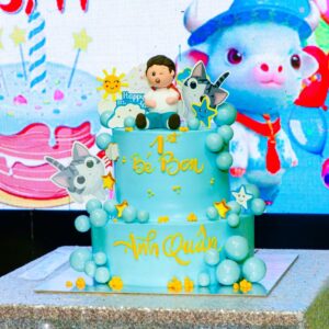 Vibrant 1st birthday cake with cartoon decorations and bright colors.